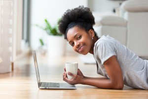 Woman-Laying-Down-Laptop-Hardwood-Floor-Coffee